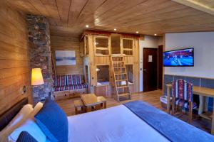ein Schlafzimmer mit einem Bett und einem TV in einem Zimmer in der Unterkunft Coma Bella in Sant Julià de Lòria