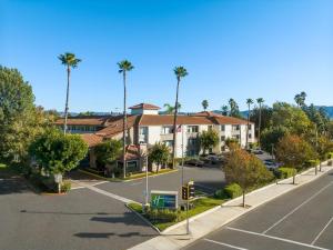 an aerial view of a parking lot with palm trees at Holiday Inn Express Simi Valley, an IHG Hotel in Simi Valley