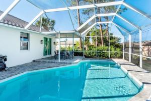 an indoor swimming pool with a pergola and a house at Tuscan Vacation Rental in Naples