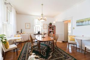 a dining room and living room with a table and chairs at West Park Gardens in Culpeper