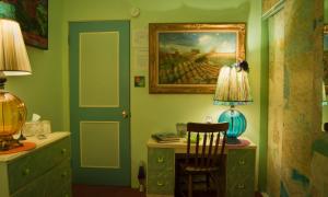 a room with a desk and a painting on the wall at The Inn at Castle Rock in Bisbee