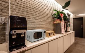 a counter with a microwave and a toaster on it at Hotel Venesian in Pohang