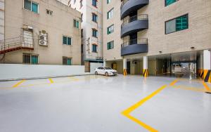 a car parked in a parking lot in front of a building at Hotel Venesian in Pohang