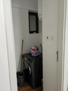 a laundry room with a washing machine and a mirror at Cosyplace at Mi Vida in Garden city in Nairobi