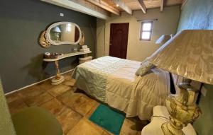 a bedroom with a bed and a mirror at Hotel Hacienda Encantada in Real de Catorce +43 photos