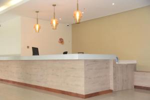 a large lobby with a reception desk with lights at SpringWells Hotel ltd in Maua