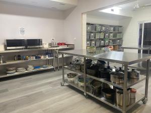 a kitchen with a counter with pots and pans at Civic Guesthouse in Townsville