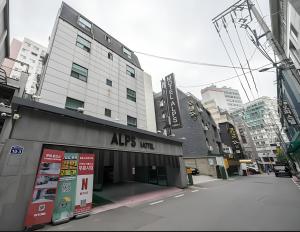 a building on a street in a city at Alps Motel in Incheon