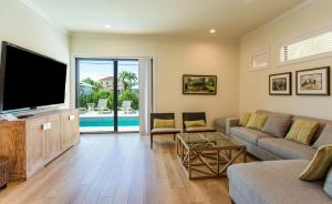 a living room with a large flat screen tv at Sorrento Vacation Rental in Naples