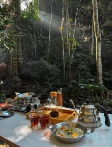 uma mesa com uma tigela de comida e uma chaleira para chá em The camp Maekampong em Ban Pok Nai