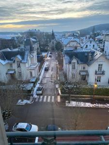 a view of a town with snow covered roofs at Studio Yannick in Vittel
