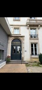 a building with a blue door in front of it at Studio Yannick in Vittel +4 photos