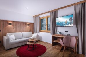 ein Wohnzimmer mit einem Sofa und einem Tisch in der Unterkunft Pension-Appartement Sonnwend in Westendorf