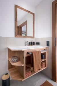 a bathroom with a sink and a mirror at Pension-Appartement Sonnwend in Westendorf