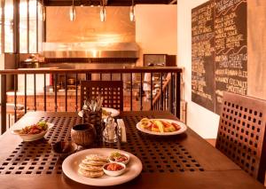 a table with plates of food on top at Spice Ella in Ella