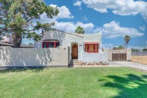 a white house with a fence and a yard at Beautiful Spanish-Styled Home in Fresno