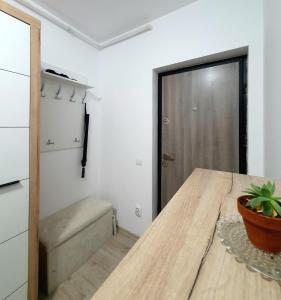 a kitchen with a wooden table and a potted plant at River park CB in Reghin