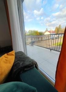 a room with a window with a view of a balcony at River park CB in Reghin