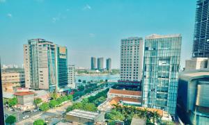 a city skyline with tall buildings and a river at Saigon Prince Hotel in Ho Chi Minh City