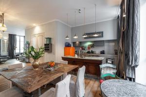 a kitchen and dining room with a wooden table at The Cosmopolitan Lodge in Cannes