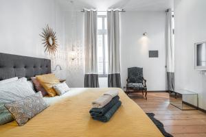 a bedroom with a large bed with pillows on it at The Cosmopolitan Lodge in Cannes