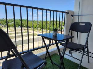 a small table and two chairs on a balcony at RnB Stayction in Lapu Lapu City
