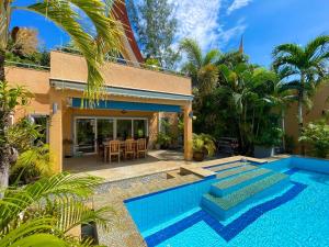 a house with a swimming pool in front of a house at Pool Villa Mali in Ko Chang