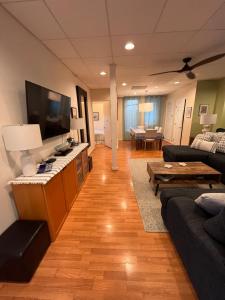 a living room with a couch and a flat screen tv at La Playa Place Getaway in San Diego