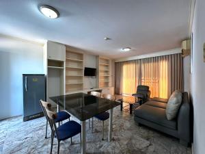 a living room with a table and a couch at Garden Paradise in Pattaya North