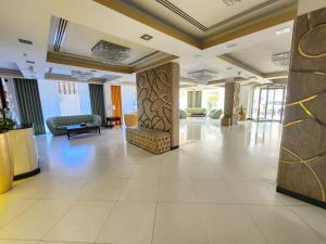 a lobby of a hotel with a waiting area at Garden Hotel Muscat By Royal Titan Group in Muscat