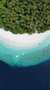 an aerial view of a beach with boats in the water at Fasdheythere Inn Maldives in Kendhoo