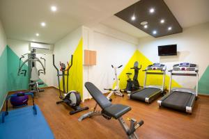 a gym with several exercise equipment in a room at Trypiti Resort Blue Dream Palace and Hive Water Park in Limenaria