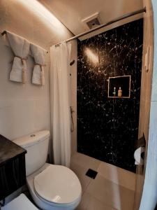 a bathroom with a toilet and a shower at Elevate at 902 - Cityscape Tower Condominium - with Netflix, Near SM, Ayala, IT Park in Mandaue City