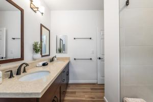 a bathroom with a sink and a shower at @Marbella Lane - 7BR home w/ Mountain+Ocean Views in Waianae