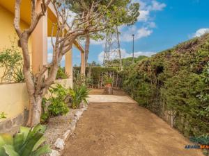 a path leading to a house with a tree at APARTBEACH EL PINAR CON PISCINA y BARBACOA in Reus