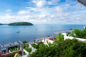 a view of the ocean with boats in the water at The Nai Harn in Nai Harn Beach