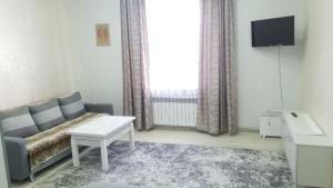 a living room with a couch and a tv at Apartment in Truskavets in Truskavets