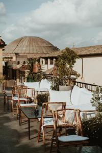 a group of chairs and tables on a patio at The Vista Rooms & Terrace in Rome