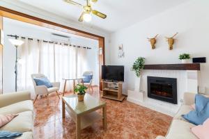 a living room with a couch and a fireplace at Mi Locura Costa Cabana in Almería