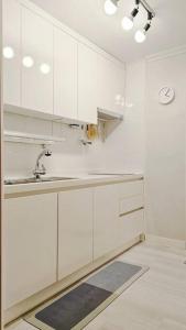 a kitchen with white cabinets and a sink at Evermore #Sinchon station 5min #Seogang station 1min in Seoul