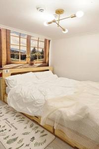 a bedroom with a white bed and a window at Evermore #Sinchon station 5min #Seogang station 1min in Seoul