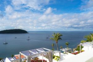 a view of the ocean from the balcony of a resort at The Nai Harn in Nai Harn Beach