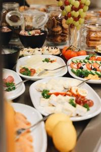 uma mesa coberta com pratos de alimentos e uvas em Outlet Hotel em Metzingen
