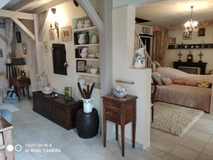 a living room with a couch and a table at La Vendemiere - Maison d'hôtes de charme et de caractère, Bretagne, Côtes d'Armror in Pont-Melvez +9 photos