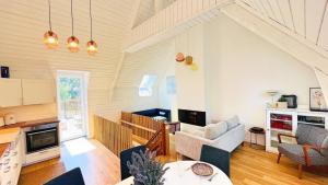a living room with a couch and a table at Villa Jacqueline, la baie du Mont-Saint-Michel in Dragey