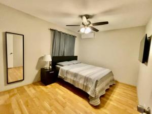 a bedroom with a bed and a ceiling fan at Spacious 1670 sq ft Single Home with Garage, AC, Centrally Located in San Diego
