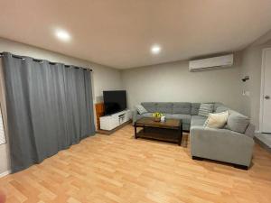 a living room with a couch and a table at Spacious 1670 sq ft Single Home with Garage, AC, Centrally Located in San Diego