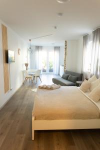 a bedroom with a large bed and a living room at HUGOS Studio Apartment in Bensheim