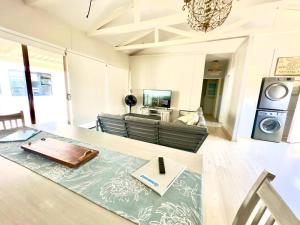 a living room with a table with a book on it at The Perfect Hartenbos Holiday Home in Mossel Bay