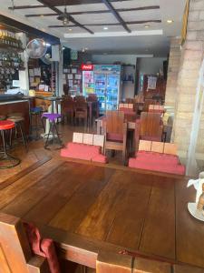 a restaurant with wooden floors and tables and chairs at Riviera Beach in Pattaya